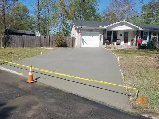 Replacement driveway being poured from the street up to a house