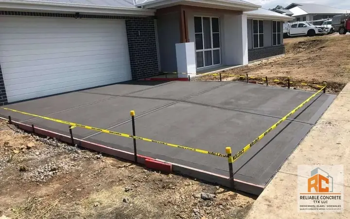 New driveway slab in front of a two-car garage