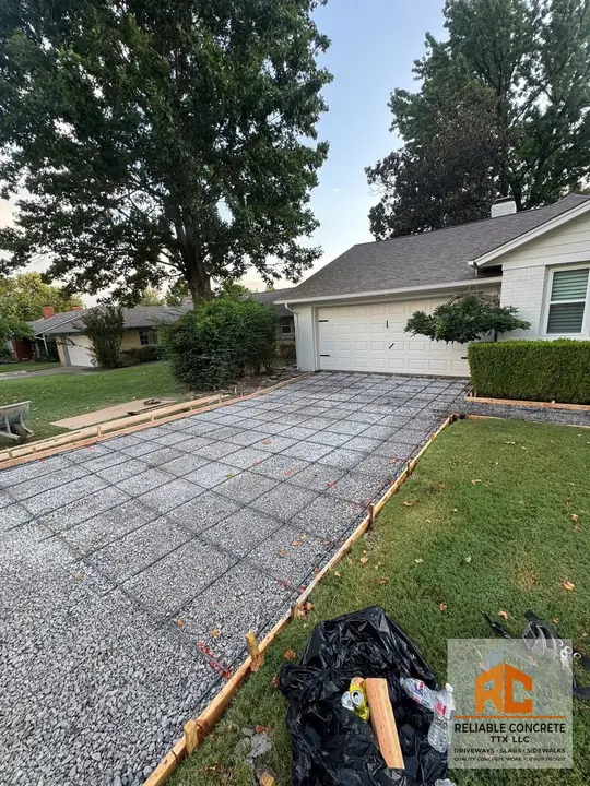 Driveway formed with rebar and gravel base in front of a garage