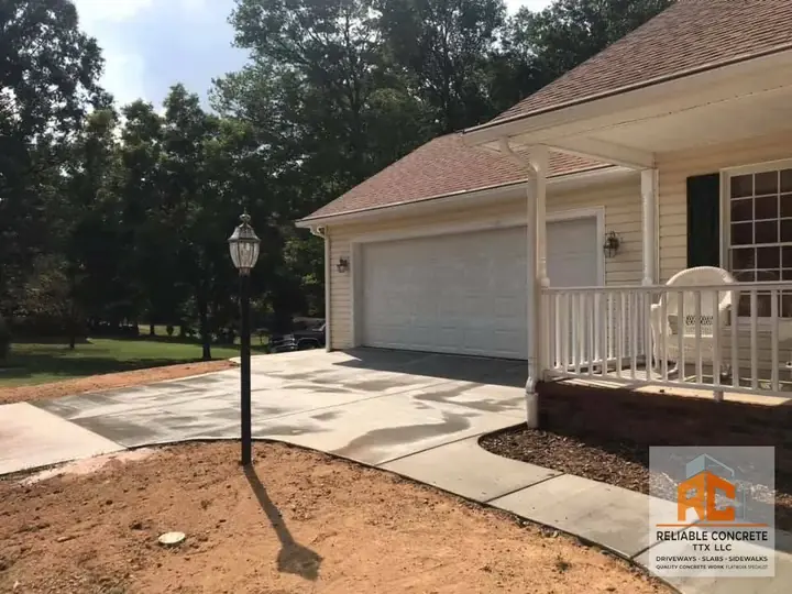 Driveway and walkway leading to a home with a white porch