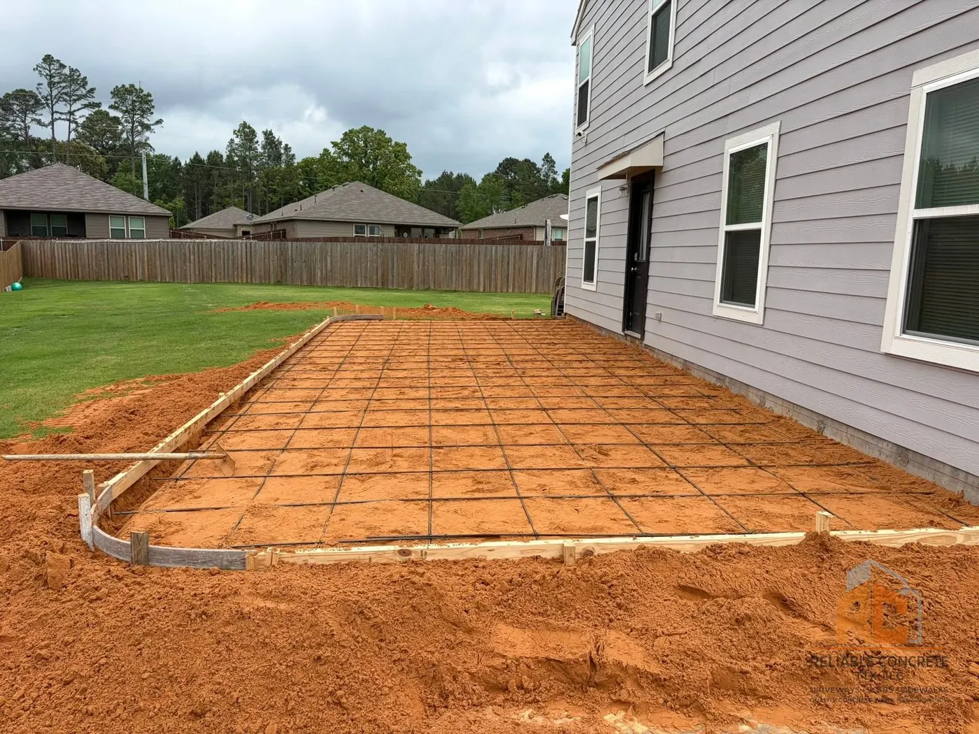 Wood forms and rebar laid out for a backyard patio