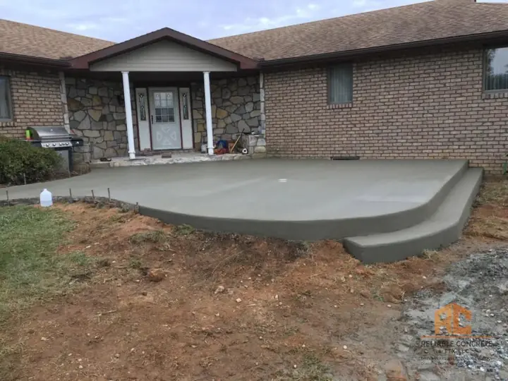 Front porch slab with a wide step on a brick home
