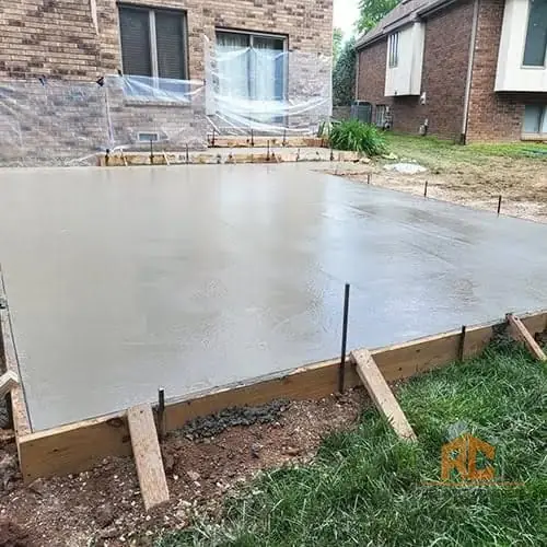 Large patio slab behind a brick home