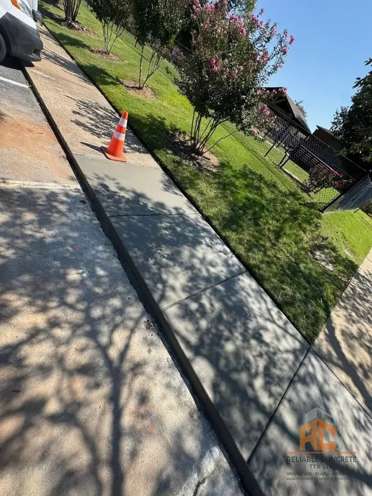Fresh concrete sidewalk running beside a lawn
