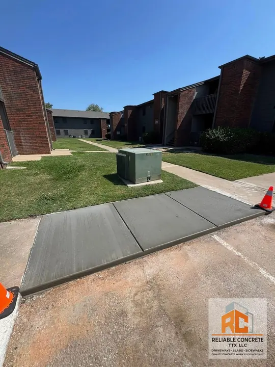 Concrete walkway poured between apartment buildings