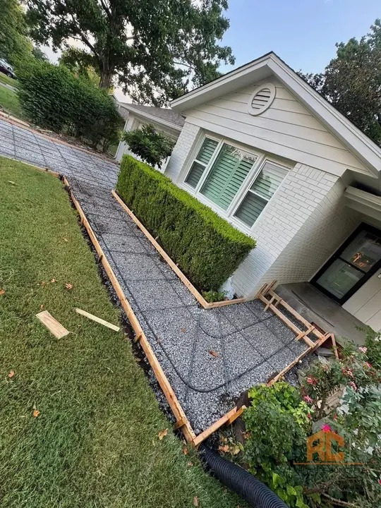 Side walkway formed with rebar along a white house