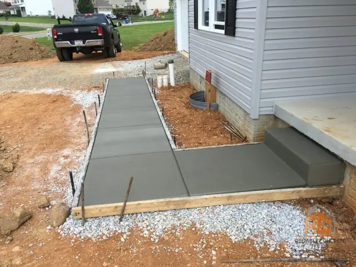 Walkway and step poured along the side of a house