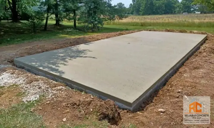 Concrete pad finished at the edge of a field